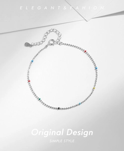 Macro shot of S925 sterling silver beaded bracelet with small multi-colored accent beads