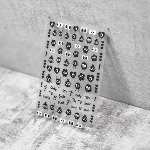 Autocollants nail art mignons avec yeux de dessin animé et motifs de cœurs noirs