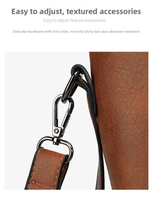 Detail of gunmetal hardware clasp and brown lychee textured leather on tote bag