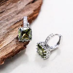 Detail of square emerald green cubic zirconia earrings with micro-pave silver stones