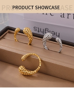 Detail of gold and silver hammered rings with honeycomb texture on a book background