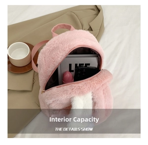 Interior view of pink plush backpack showing spacious capacity for books and phone