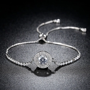 Detail of adjustable silver bracelet with round zircon center and tennis chain style link
