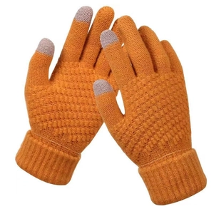 Detail of knitted winter touchscreen gloves in orange with conductive fingertips on white