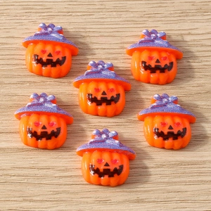 Close-up of orange resin pumpkins with purple wizard hats for Halloween DIY crafts