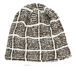 Detail of the soft knit texture and brown checkered pattern of the winter beanie