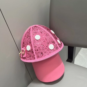 Detail of a pink mushroom-shaped handbag featuring sparkling rhinestones and white dots