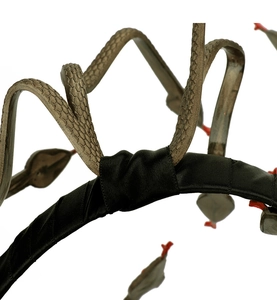 Macro view showing the detailed snake scales and black satin texture of the Medusa headband