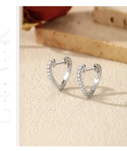 Detailed view of heart-shaped S925 sterling silver hoop earrings with VVS1 clarity stones