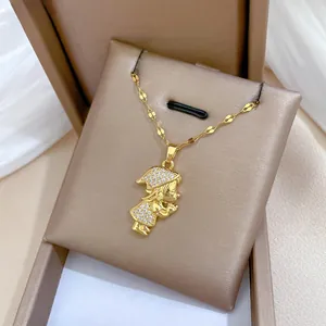 Detail of gold-plated titanium steel necklace featuring a crystal-encrusted girl pendant