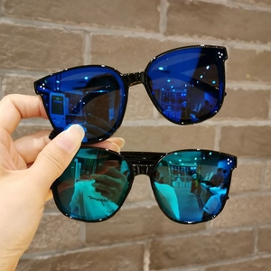 Detail of children's sunglasses with dark blue and green mirror lenses and rivets