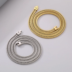 Detailed view of woven dragon bone chains in gold and silver finish with box clasps