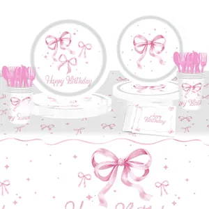 Detailed view of pink bow party tableware set including paper plates and cups for birthdays