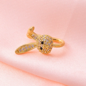 Close-up of golden rabbit nose clip ring with micro-pave zircons on pink silk