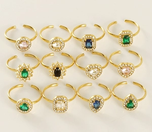 Detailed grid of adjustable 18K gold rings featuring multi-color gemstones and crystals