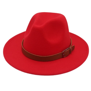 Detail of red wool felt fedora featuring a brown leather band and metal belt buckle accent