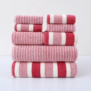 Macro detail of red and white striped towel set featuring dense and wide pattern textures