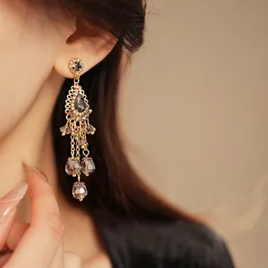 Vintage water drop tassel earrings with grey crystals in a luxurious gold setting