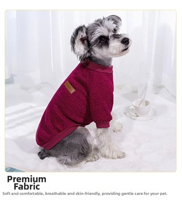 Detail of dark rose pet sweater with ribbed cuffs and classic leather patch on soft fabric