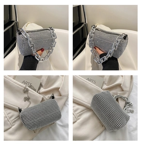 Detailed view of silver rhinestone cylinder handbag with chunky chain and long strap