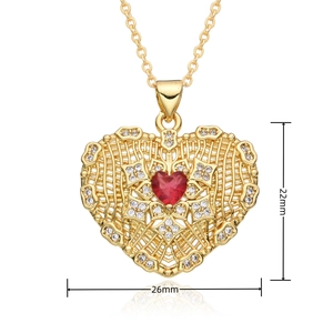 Macro shot showing dimensions 22x26mm of gold heart pendant with red stone and zircons