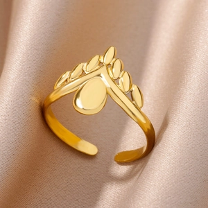 Close-up of a minimalist 18k gold plated stainless steel hollow crown ring on champagne silk