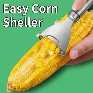 Manual stainless steel corn peeler tool removing fresh kernels from the cob