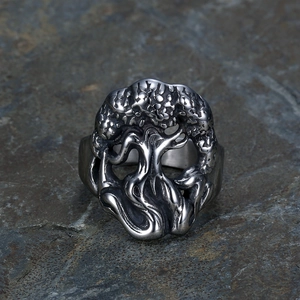 Macro detail of silver tree of life ring with vintage oxidation on stone background