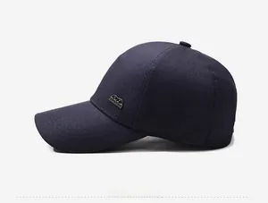Detail view of navy blue baseball cap side profile with silver metal decorative buckle