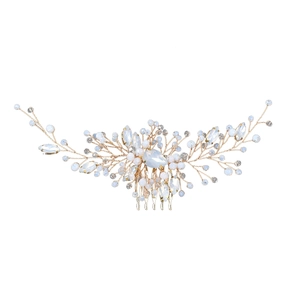 Detail of bridal hair comb with gold wire, emerald green crystals and white pearls