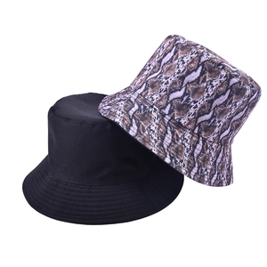 Reversible bucket hat with snakeskin print and solid black design for sun protection