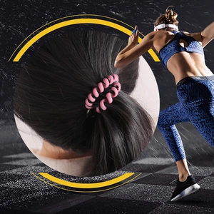 Pink spiral phone cord hair tie used for ponytail on a female athlete in sports scene