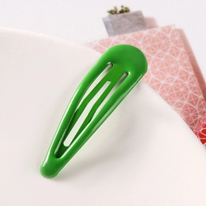 Detailed view of glossy green waterdrop snap hair clip with smooth metal finish