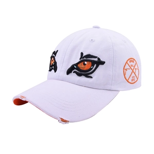 Detail of white baseball cap showing orange eye embroidery and distressed brim effect