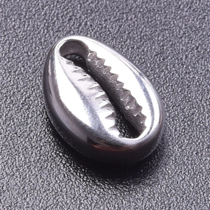 Macro detail of a silver shell charm pendant with a polished finish and inner teeth structure