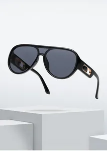 Detail of classic black aviator sunglasses featuring stylish gold hollow-out temple design