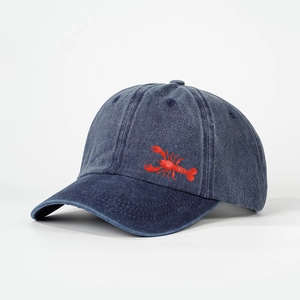 Close-up of vintage navy washed denim baseball cap with red lobster embroidery detail