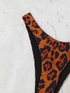 Detailed view of leopard print bikini bottom side tie with high-elastic fabric texture
