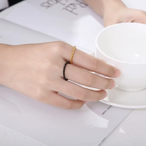 Minimalist 2mm twisted stackable rings in gold and black stainless steel for women