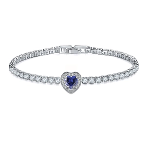 Macro detail of heart-shaped blue gemstone tennis bracelet with silver-tone metal finish