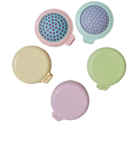 Flat lay of five colorful foldable hairbrushes with mirrors in pink blue yellow and green