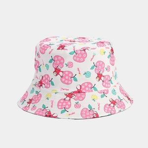 Detail view of white canvas bucket hat featuring pink apple and cute cartoon mouse prints