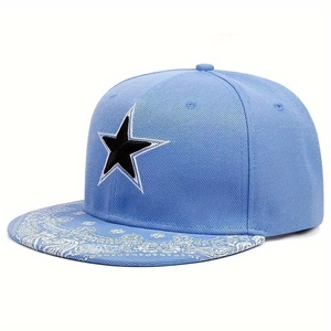 Detail of light blue snapback hat with black star embroidery and paisley printed brim