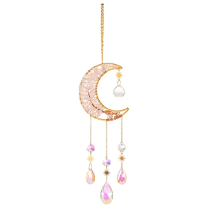 Detail of moon-shaped crystal tree of life dreamcatcher with gold wire and pink stones