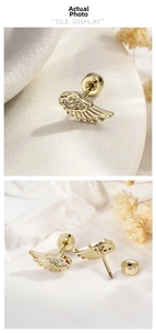 Macro shot of gold angel wing earrings with clear zircons and screw back closures