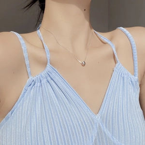Close-up of S925 sterling silver ball pendant necklace on a model's collarbone