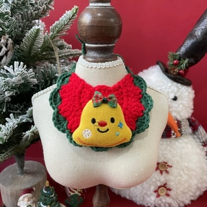 Detailed macro view of handmade crochet Christmas pet collar with a bell ornament