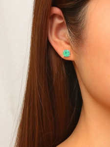 Side close-up of 6mm green opal stud earrings with gold plating on a model's ear