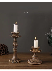 Detailed view of vintage engraved resin candlesticks with flickering white pillar candles