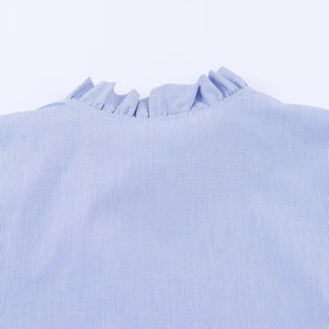 Detailed view of the layered ruffle collar on a blue and white striped poplin shirt